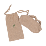 The Lingua Franca x High Line 100% Cashmere Eye Mask with travel case. This oatmeal-colored eye mask comes with a 100% cashmere travel bag embroidered with the High Line icon in green.