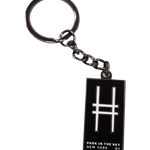 Enamel keychain with the High Line railroad-track "H" icon and "Park in the Sky, New York NY" in all caps.