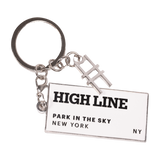 The High Line Tag Keychain, featuring a small charm of the High Line railroad-track "H" icon and a rectangle with the High Line wordmark and "Park in the Sky, New York NY" in black on white enamel.