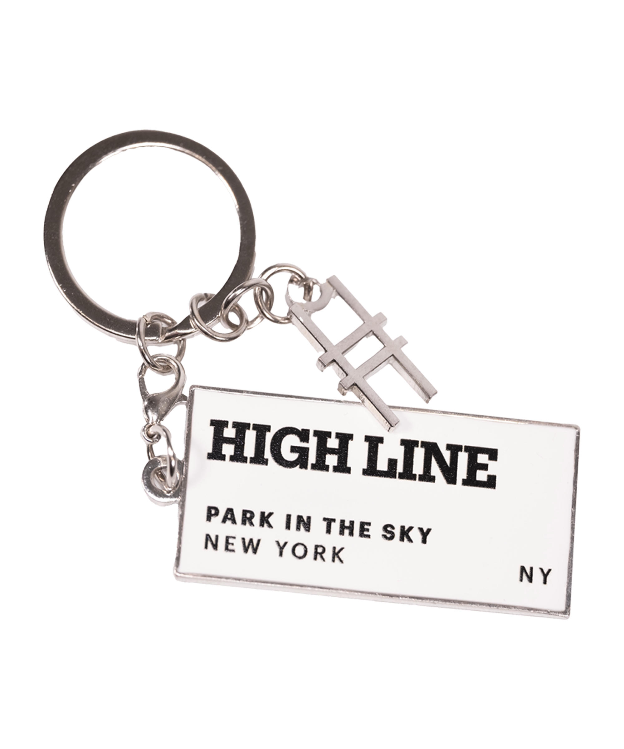 The High Line Tag Keychain, featuring a small charm of the High Line railroad-track "H" icon and a rectangle with the High Line wordmark and "Park in the Sky, New York NY" in black on white enamel.
