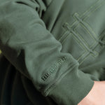 Big Icon Crewneck in Ivy with monochromatic embroidery details. Front features big High Line icon and High Line wordmark on sleeve. Close-up on embroidery details.