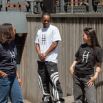 Three people, all in Big Icon Tees, laughing with each other.