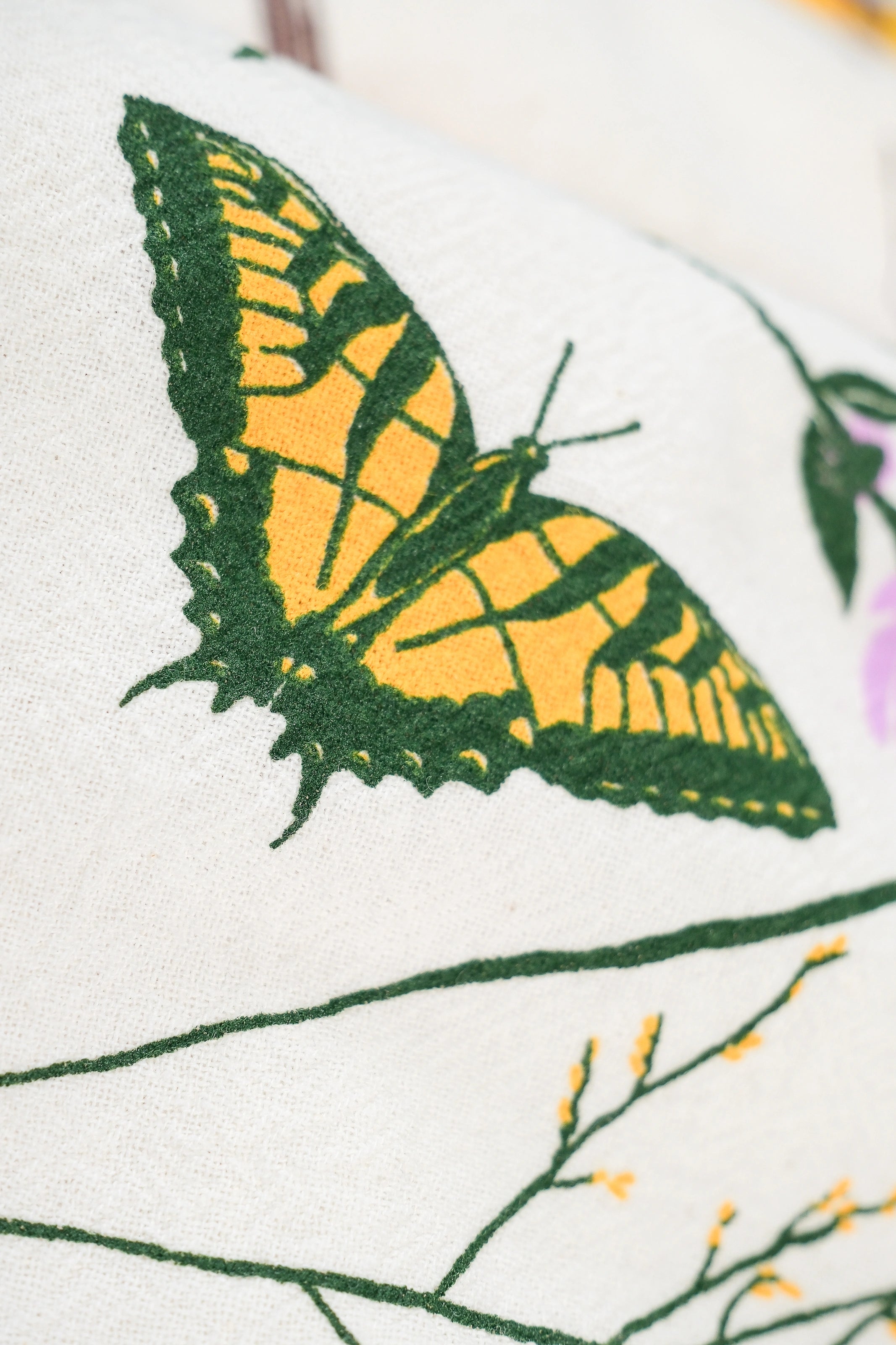 Illustrated butterfly amidst the flora on the Claudia Pearson x High Line Chelsea Grassland tea towel. 