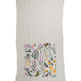 Claudia Pearson x High Line Chelsea Grassland tea towel, shown in full. The flour sack cotton tea towel is half covered in illustrations of the flowers and grasses that grow in the Chelsea Grassland area of the High Line in pale purple, deep green and yellow.