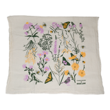 Claudia Pearson x High Line Chelsea Grassland tea towel, folded in half. The flour sack cotton tea towel is covered in illustrations of the flowers and grasses that grow in the Chelsea Grassland area of the High Line in pale purple, deep green and yellow.