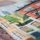 Close-up of the Community in the Sky Tote—NYC buildings and people hanging out on rooftops and fire escapes are in focus.