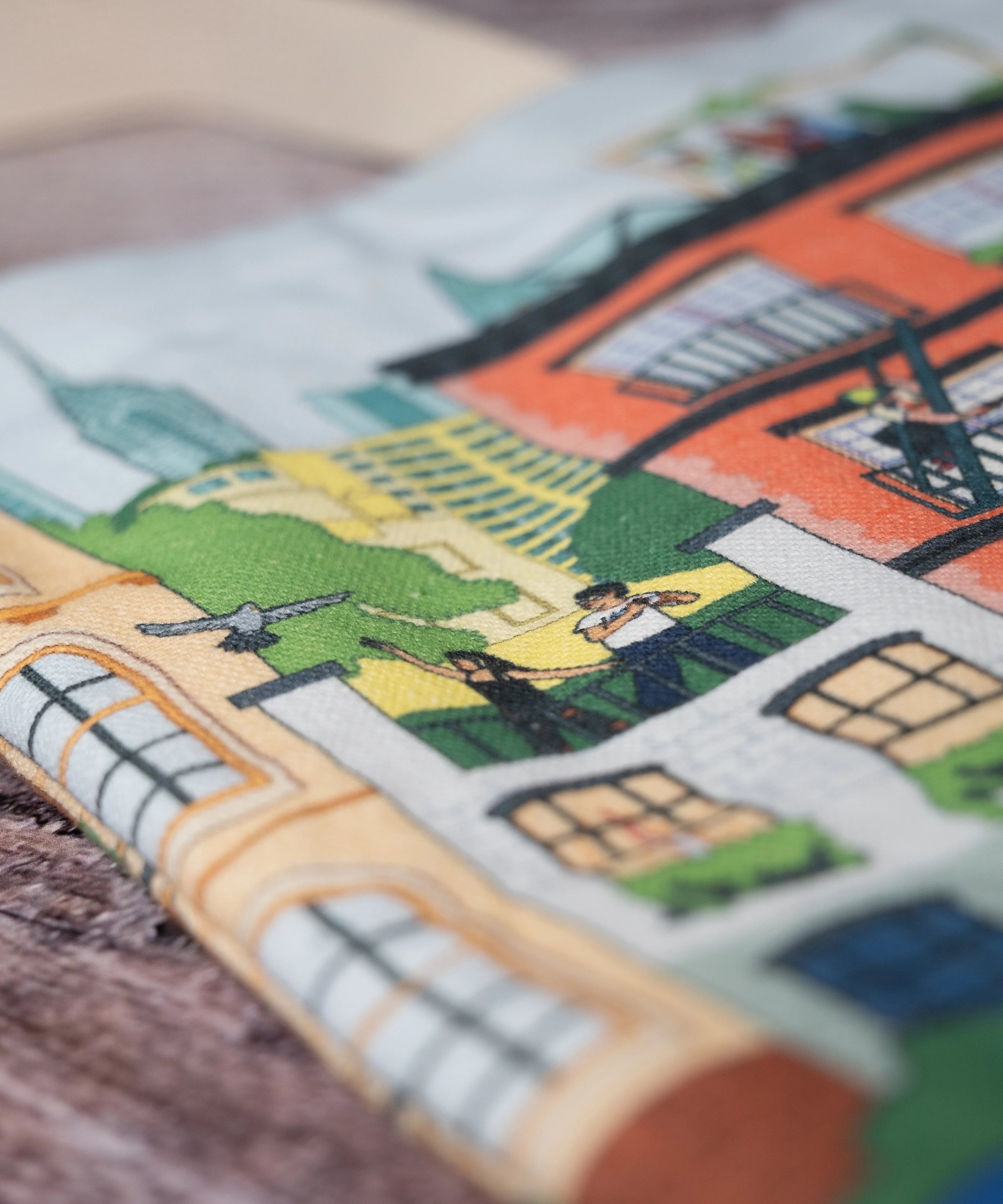 Close-up of the Community in the Sky Tote—NYC buildings and people hanging out on rooftops and fire escapes are in focus.