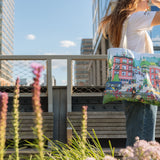 Woman with the Community in the Sky Tote standing on the High Line.