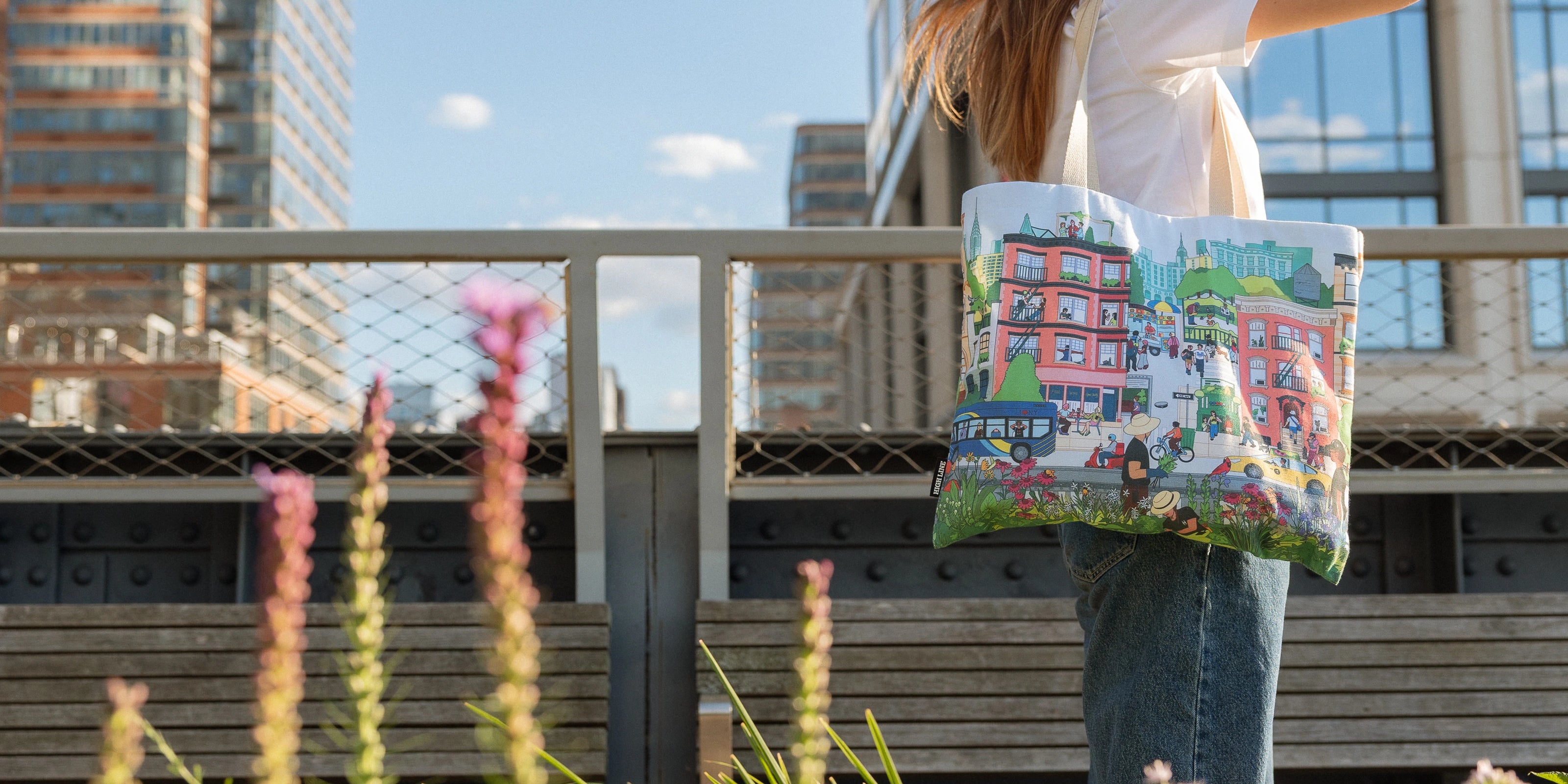 Woman with the Community in the Sky Tote standing on the High Line.