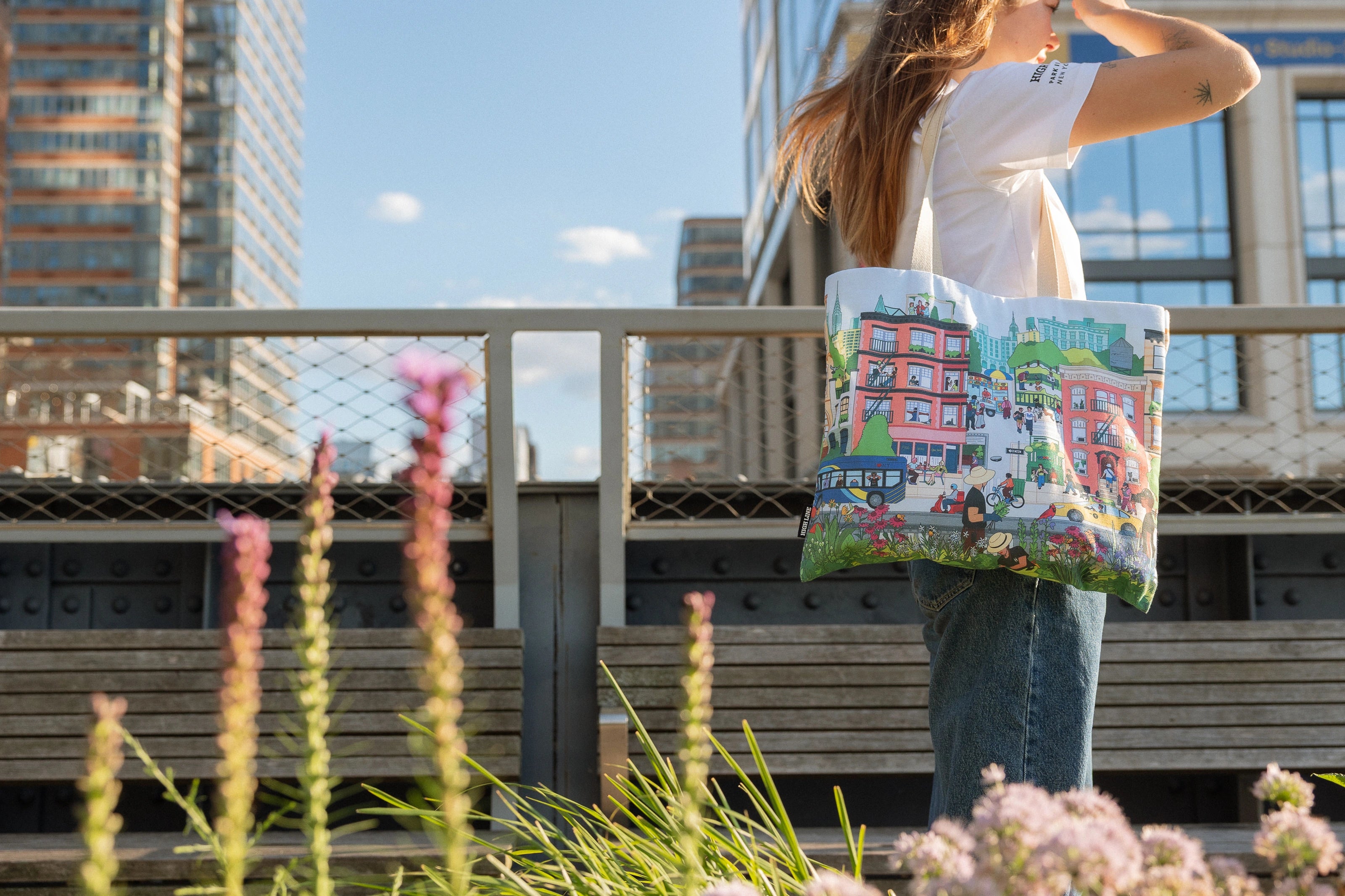 Woman with the Community in the Sky Tote standing on the High Line.