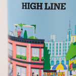 Closeup of stainless steel water bottle with a colorful design and 'High Line' branding on a blue background with wooden lid. Features the Nature in the City illustration by Jiaqi Wang.
