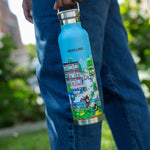 Woman holding the Community in the Sky water bottle while walking on the High Line.