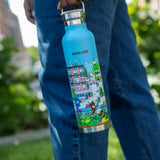 Woman holding the Community in the Sky water bottle while walking on the High Line.