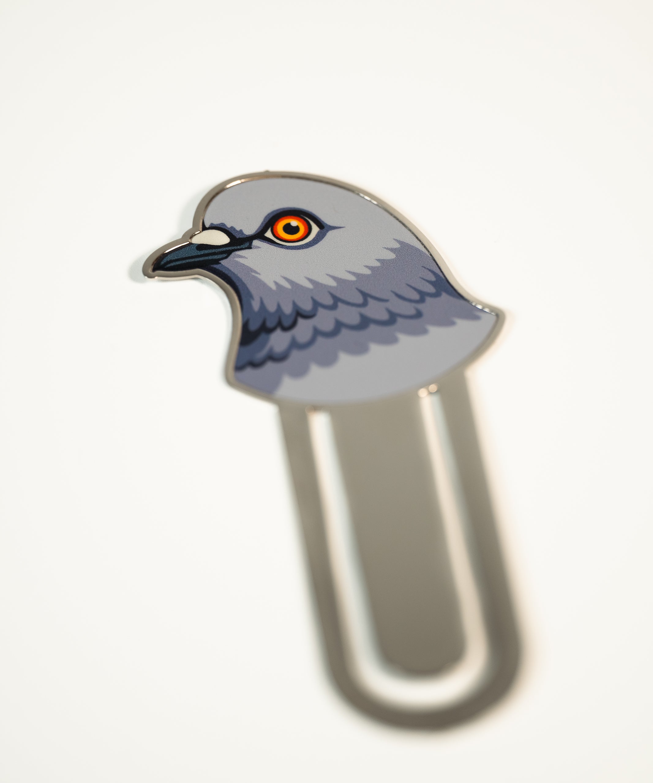 Metal bookmark featuring a pigeon head.