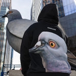 Person wearing the Dinosaur Hoodie, looking up at the Dinosaur statue when it was on view at the Plinth on the High Line. 