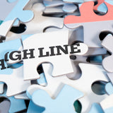 Closeup on puzzle pieces, showing the High Line wordmark and part of the pigeon's face.