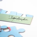 Puzzle pieces with Iván Argote's signature pieced together.