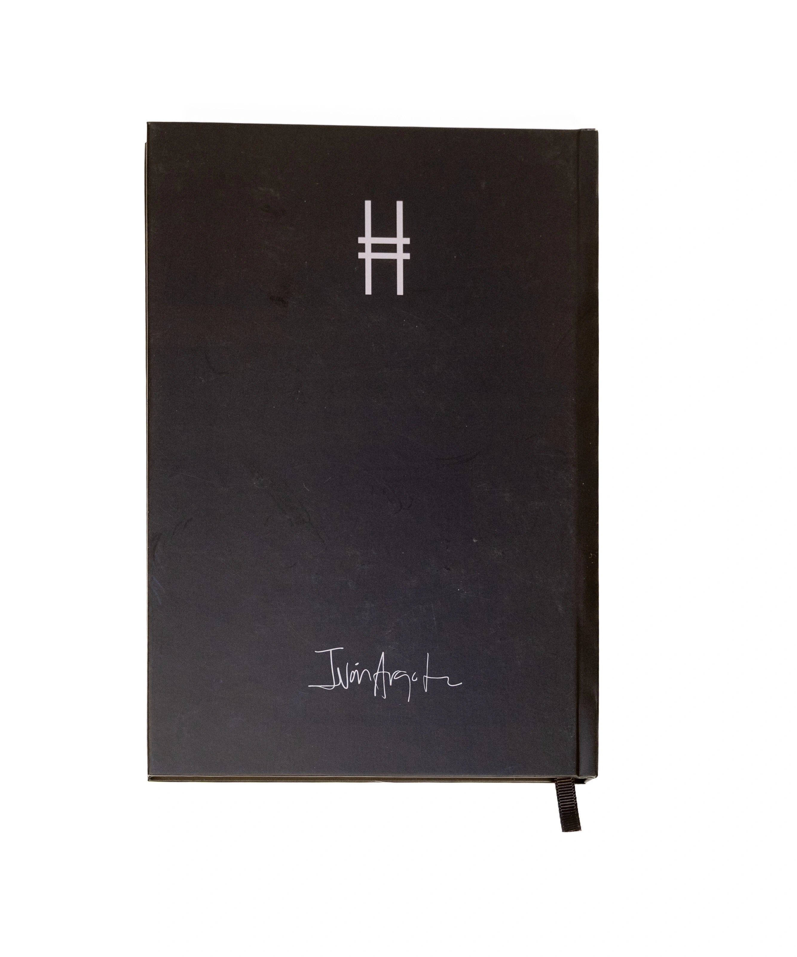 Back cover of black Dinosaur Notebook, featuring the High Line icon and Dinosaur artist Iván Argote's signature.