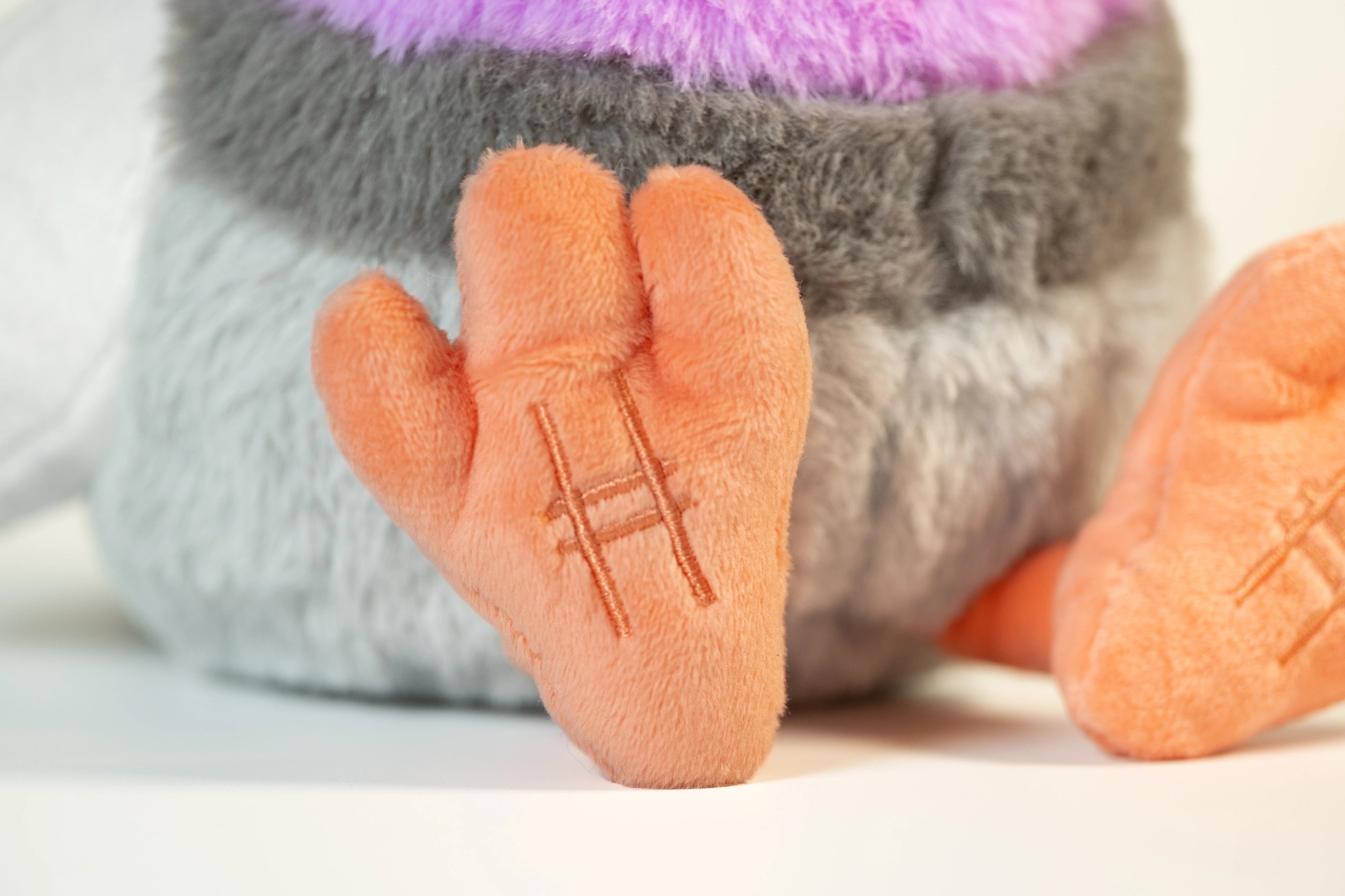 Close up of Pigeon Plush feet with embroidered High Line icon.