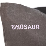 Closeup of "Dinosaur" printed in lavender against the black tote.