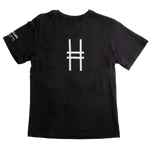 A black short-sleeve crewneck t-shirt featuring the High Line icon printed on the center chest, with white text on the left sleeve that reads "High Line. Park in the Sky. New York NY"