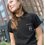 Woman wears the High Line Embroidered black Pocket Tee on the High Line.