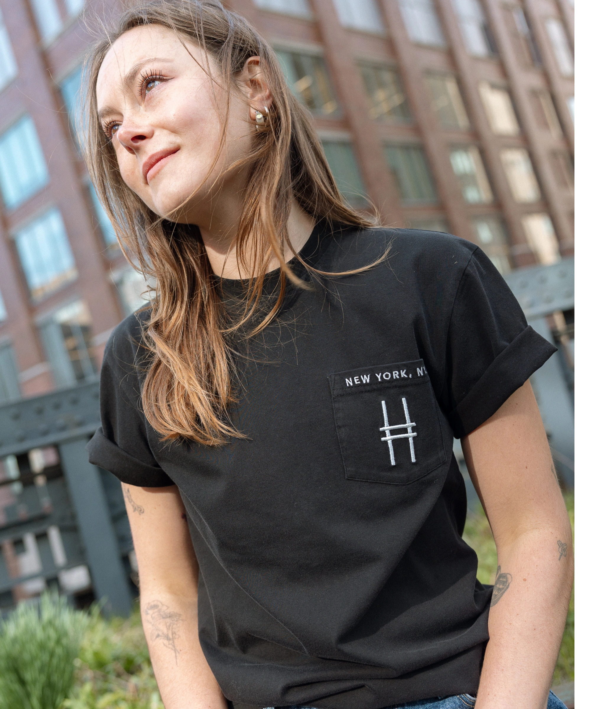Woman wears the High Line Embroidered black Pocket Tee on the High Line.