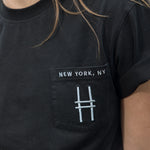 Woman wears the High Line Embroidered black Pocket Tee on the High Line.