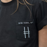 Woman wears the High Line Embroidered black Pocket Tee on the High Line.