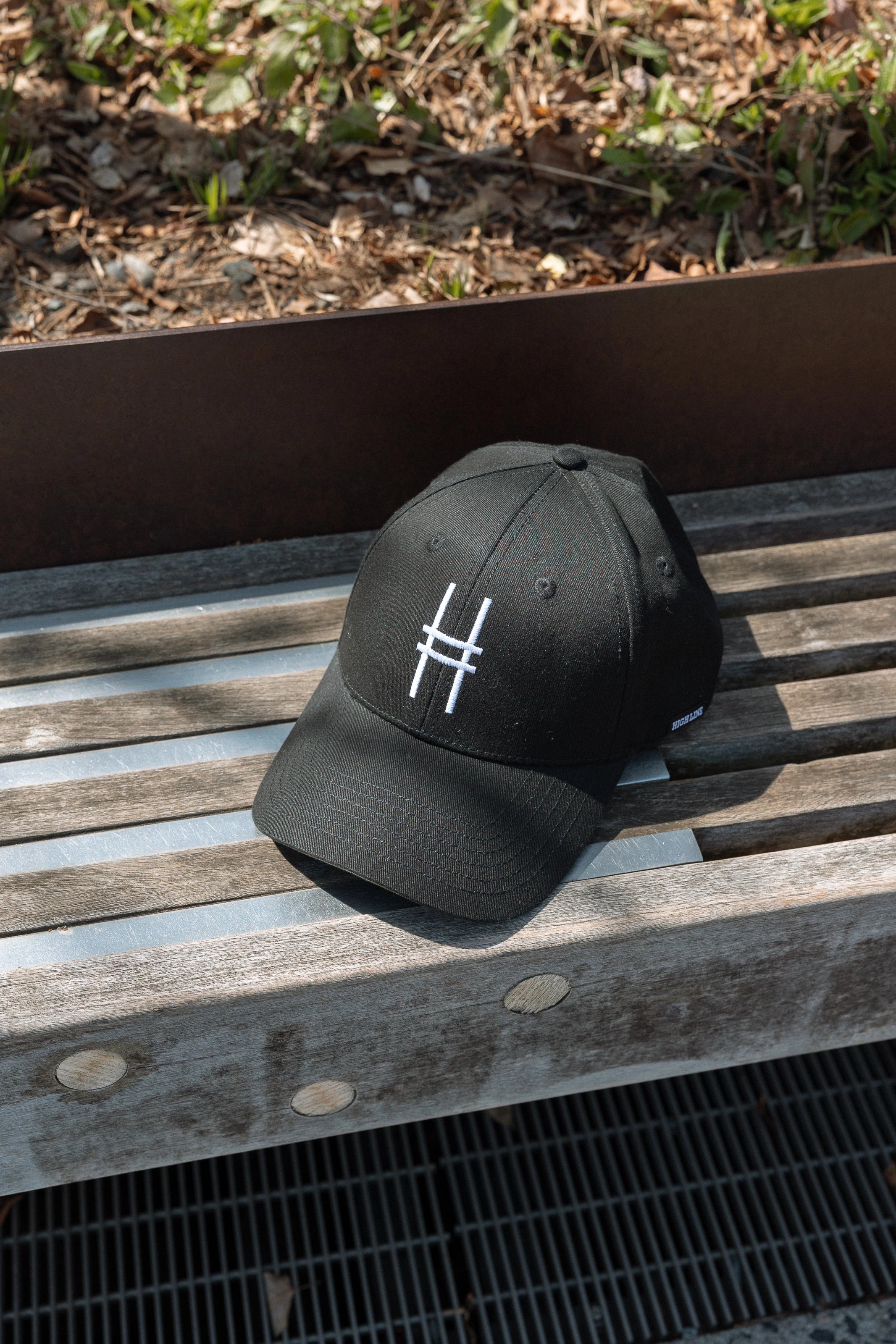 High Line Icon Contrast Cap on a bench on the High Line.