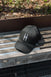 High Line Icon Contrast Cap on a bench on the High Line.