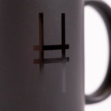 Detailed shot of High Line Mug in Black, featuring the High Line icon in gloss against black matte ceramic.