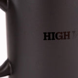 Detailed shot of the High Line Mug in Black, featuring the High Line wordmark in gloss against black matte ceramic.