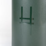 Closeup of High Line Mug in Ivy, featuring the High Line icon in gloss against dark green matte ceramic.