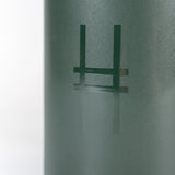 Closeup of High Line Mug in Ivy, featuring the High Line icon in gloss against dark green matte ceramic.