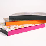 Three notecard sets, each with a different color box side, stacked on top of each other. 