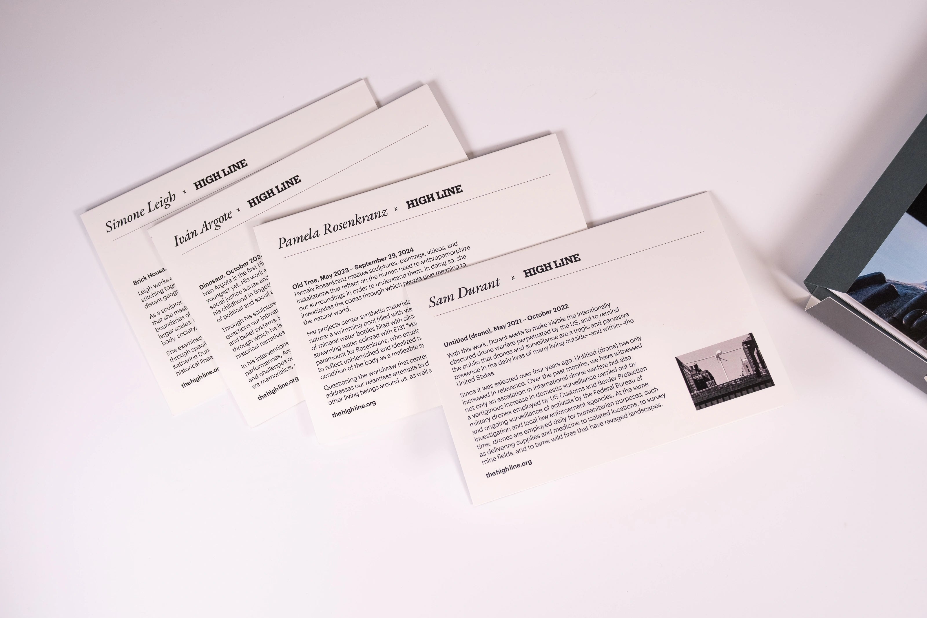 The backs of four of the eight notecards in the HIgh Line Plinth set—each featuring a different  Plinth Commission recipient and a bit about their statue.