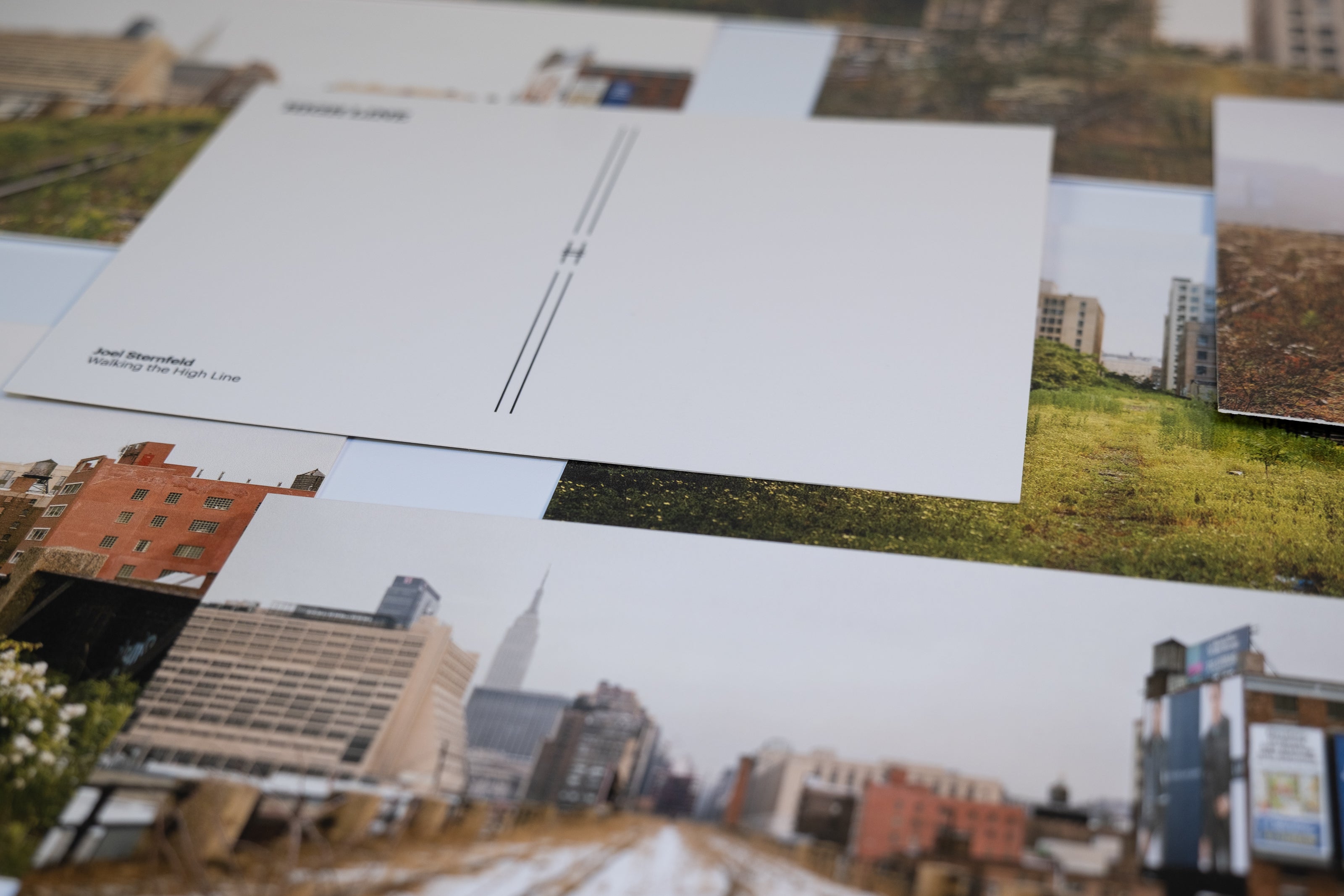 Closeup of Joel Sternfeld Postcards scattered and overlapping.