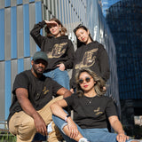 Four people, each wearing either The Light That Shines... Hoodie or Tee, on the northern end of the High Line.