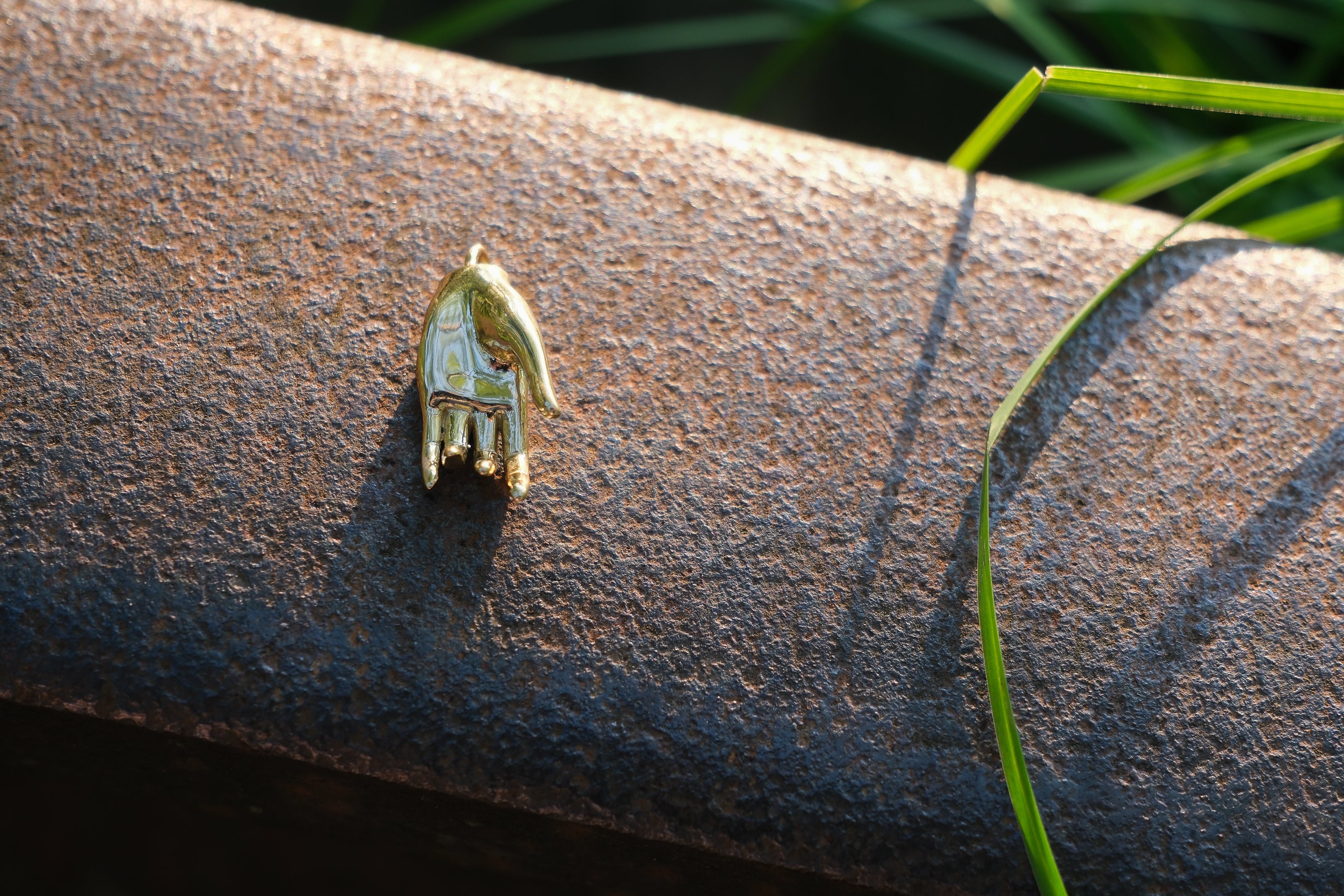 Varada mudra pendant resting on rail track