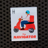 The Navigator acrylic magnet on a black locker.