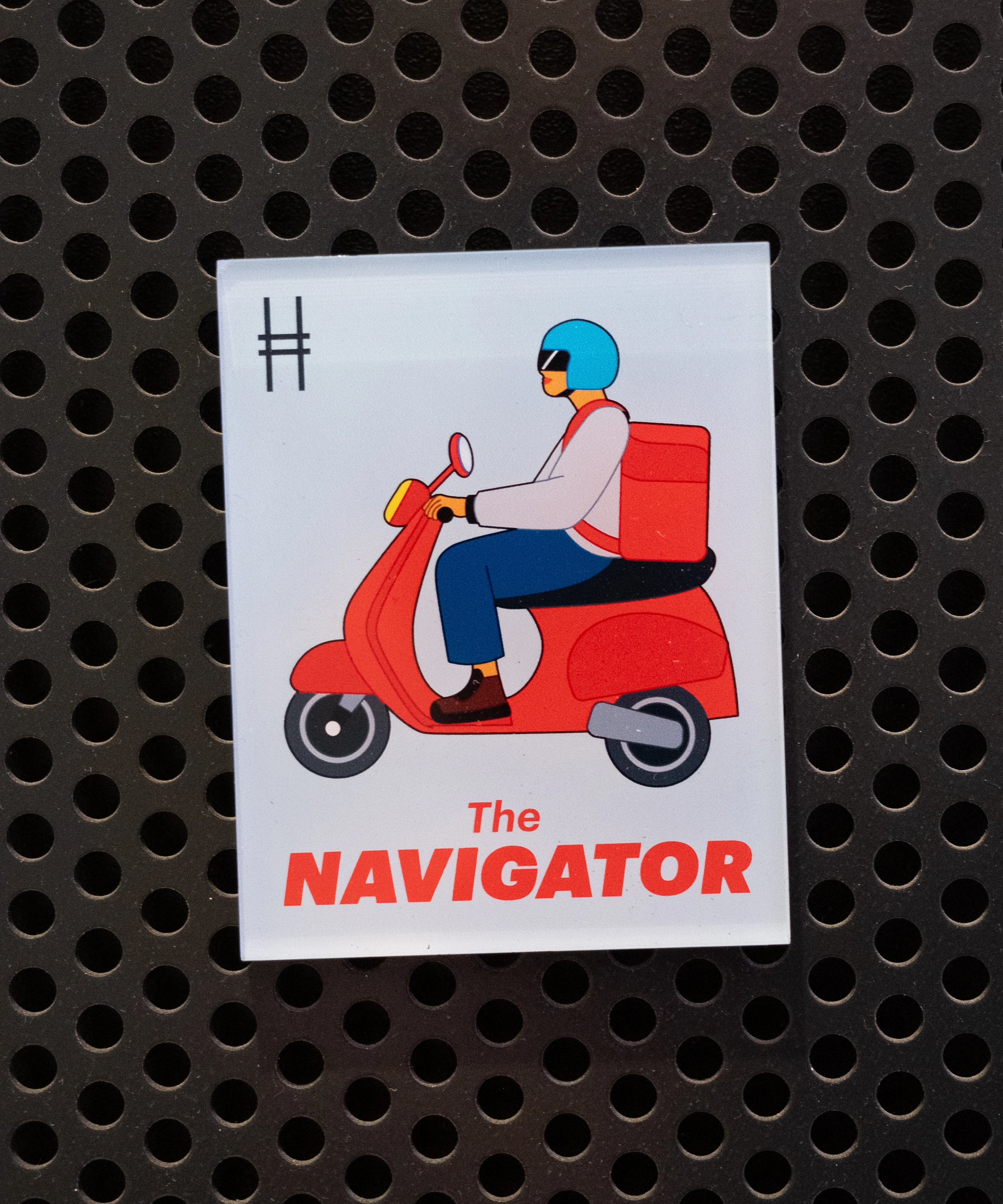 The Navigator acrylic magnet on a black locker.