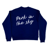 The Park in the Sky embroidered crewneck sweatshirt in navy—a navy blue crewneck sweatshirt shown from the back, featuring the phrase 'Park in the sky' embroidered in white cursive script across the upper back.