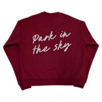 Park in the Sky Crewneck in Smokebush, a deep, burgundy red. "Park in the Sky" in script is appliquéd across the back in white.