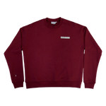 Park in the Sky Crewneck in Smokebush. Front features a chest ribbon detail with the High Line logo and "New York NY" as well as a small woven patch with the High Line railroad track-inspired "H" icon sewn on the right sleeve. Smokebush is a deep, burgundy red.