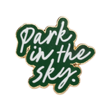 Our Park in the Sky pin sets the phrase "park in the sky" in white against green enamel.