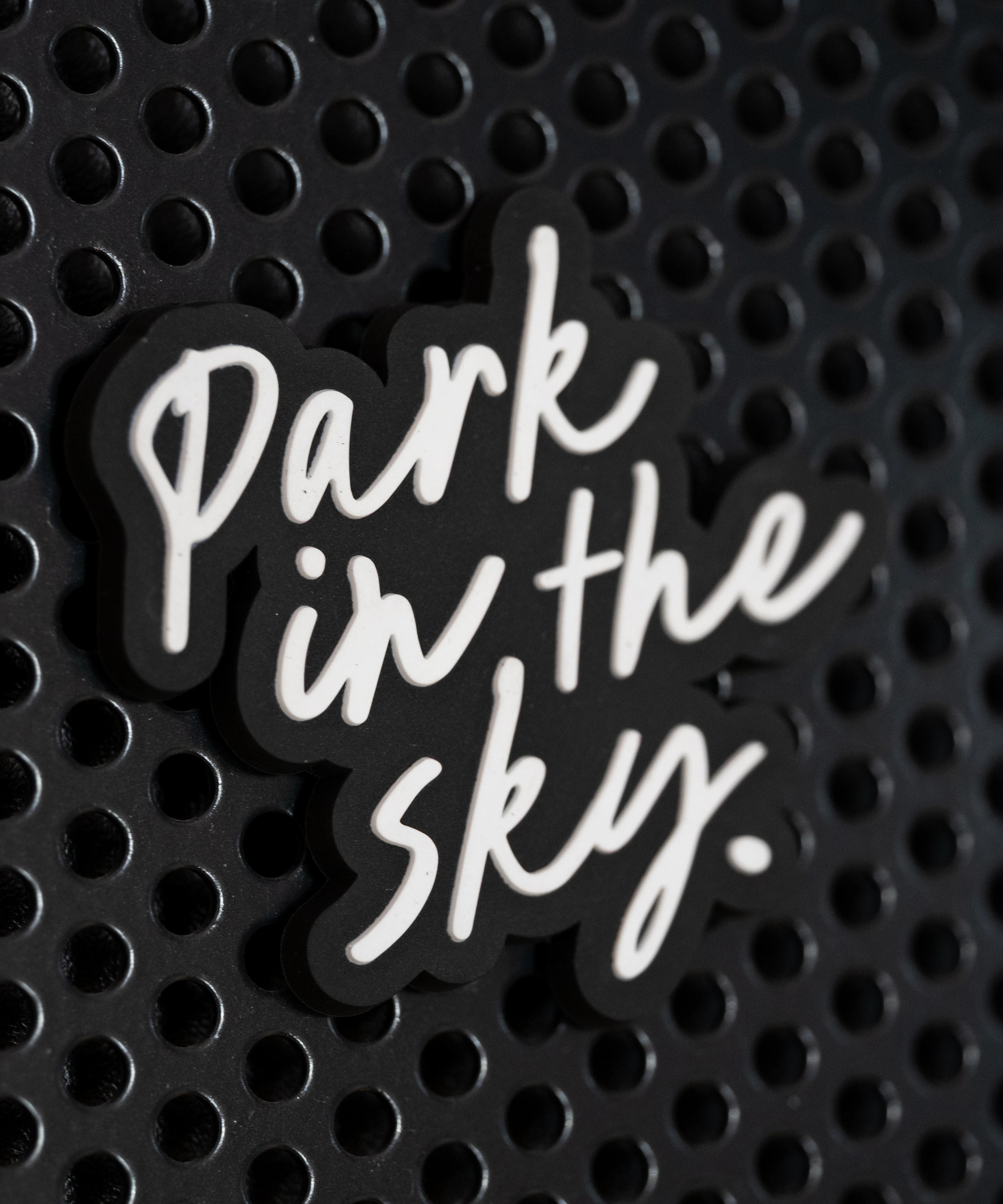 Park in the Sky rubber fridge magnet on a black metal locker.