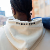 Woman wearing Park in the Sky crewneck and man in the Park in the Sky hoodie, with embroidery on the hoodie visible.