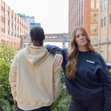 Woman wearing Park in the Sky crewneck and man in the Park in the Sky hoodie, with crewneck front and hood detail embroidery on the hoodie visible.
