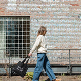 Woman walking along the High Line, swinging the Park in the Sky Tote.
